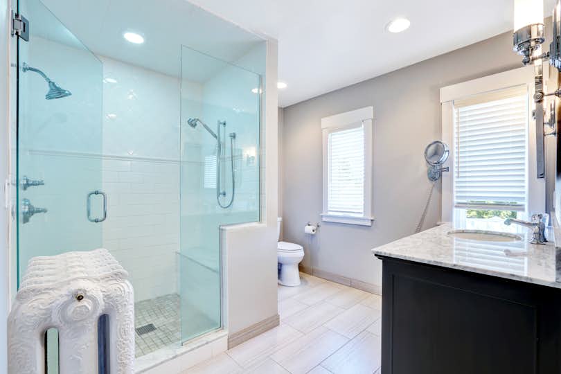 Refreshing bathroom with large glass walk in shower