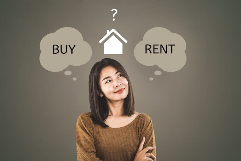 woman thinking buy or rent home concept with question mark in background price-to-rent ratio rent vs. buy