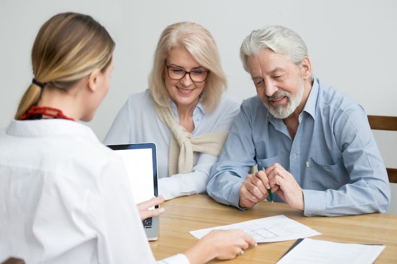 Older couple meeting with real estate agent about quitclaim deed.
