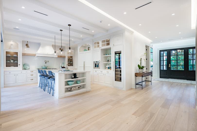 Elegant modern farmhouse interior kitchen dining with light wood floors throughout