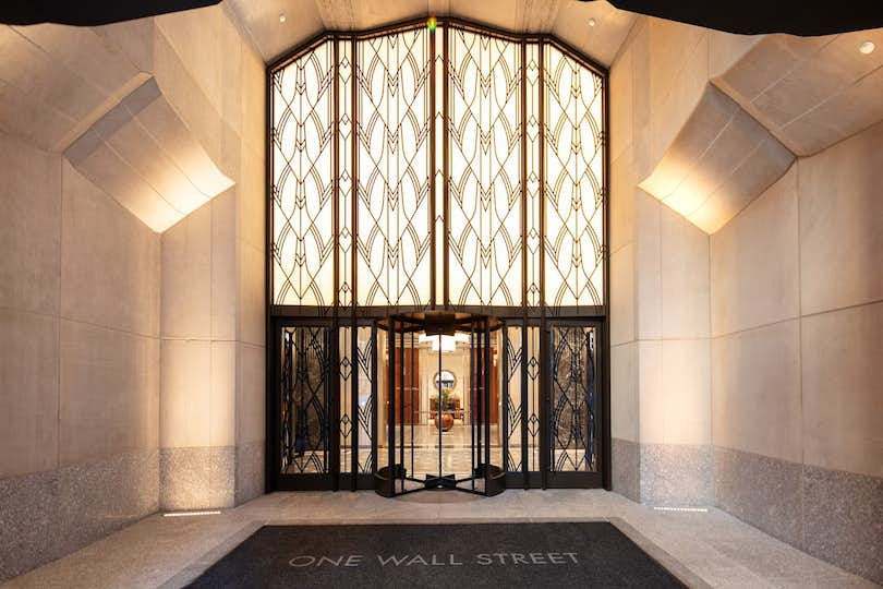 the entrance to One Wall Street in New York City