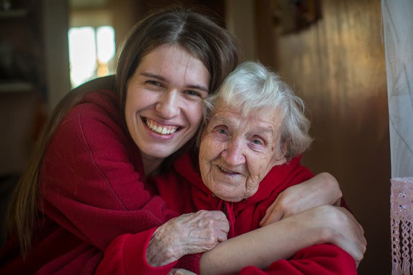 Younger woman hugs older woman