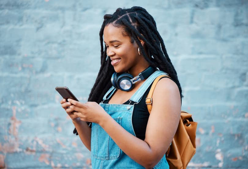 Young woman looking at her cellphone