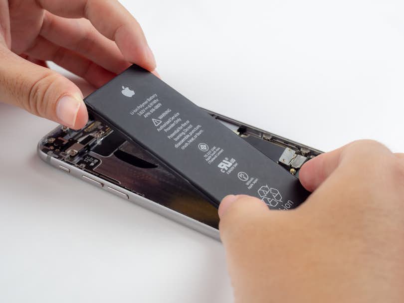 Lithium-ion battery being placed in an iPhone
