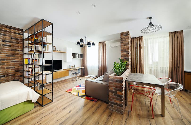 A loft apartment with clearly defined zones for sleeping, eating, working, and relaxing