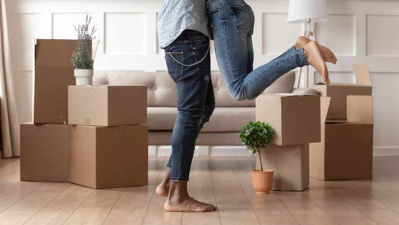 First-time homebuyer couple hugging