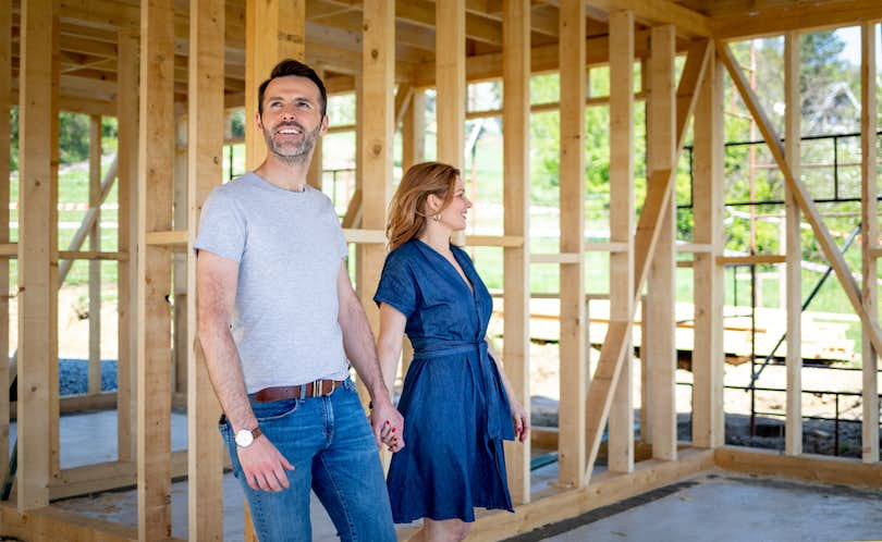 Couple walk through home under construction